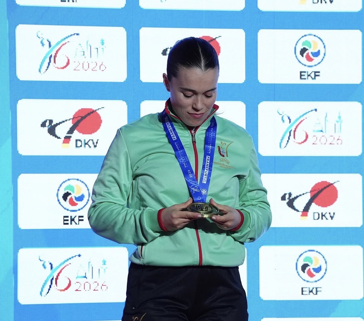 Ana Sofia Cruz on the EKF Frankfurt 2026 podium, looking at her bronze medal